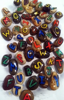 Small rocks with each letter of the English alphabet written on them