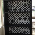 A close up of an IKEA Billy Bookcase makeover painting it black with a white and black print background