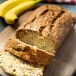 sliced loaf of banana bread on cutting board