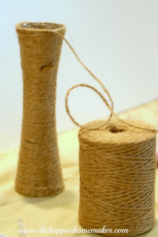 An in progress picture of how to wrap jute around a glass vase 