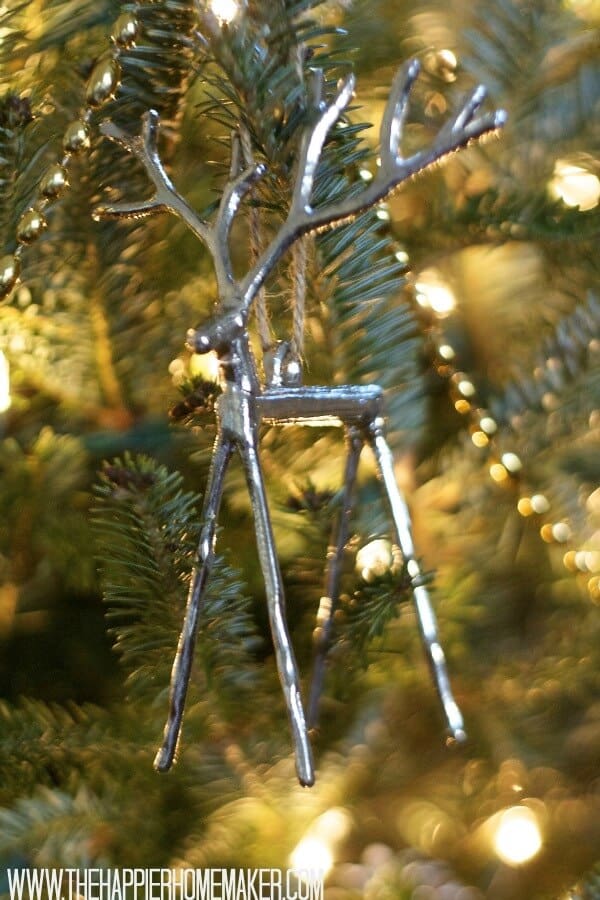 A close up of a silver deer Christmas ornament 