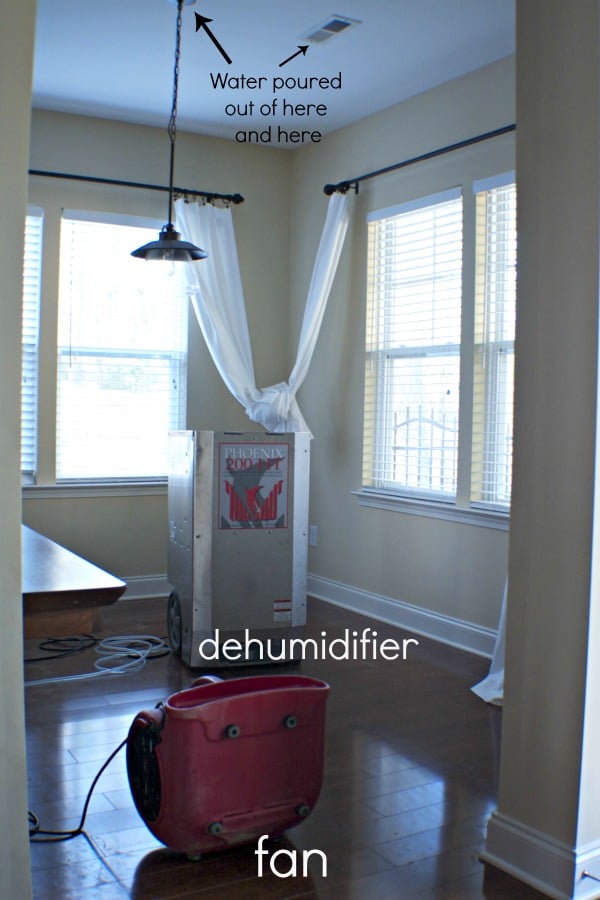 An eat in kitchen with a large dehumidifier in the center of the room