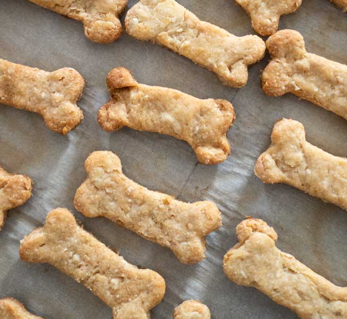 A close up of homemade dog treats sitting on a baking pan