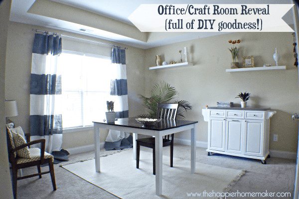 A finished office or craft room complete with a table, storage unit and decorative shelves