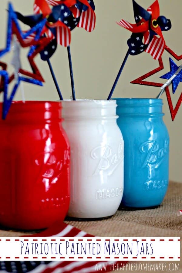 mason jars painted red, white, and blue with patriotic stars on sticks 