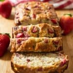 A loaf of banana bread sliced on a cutting board