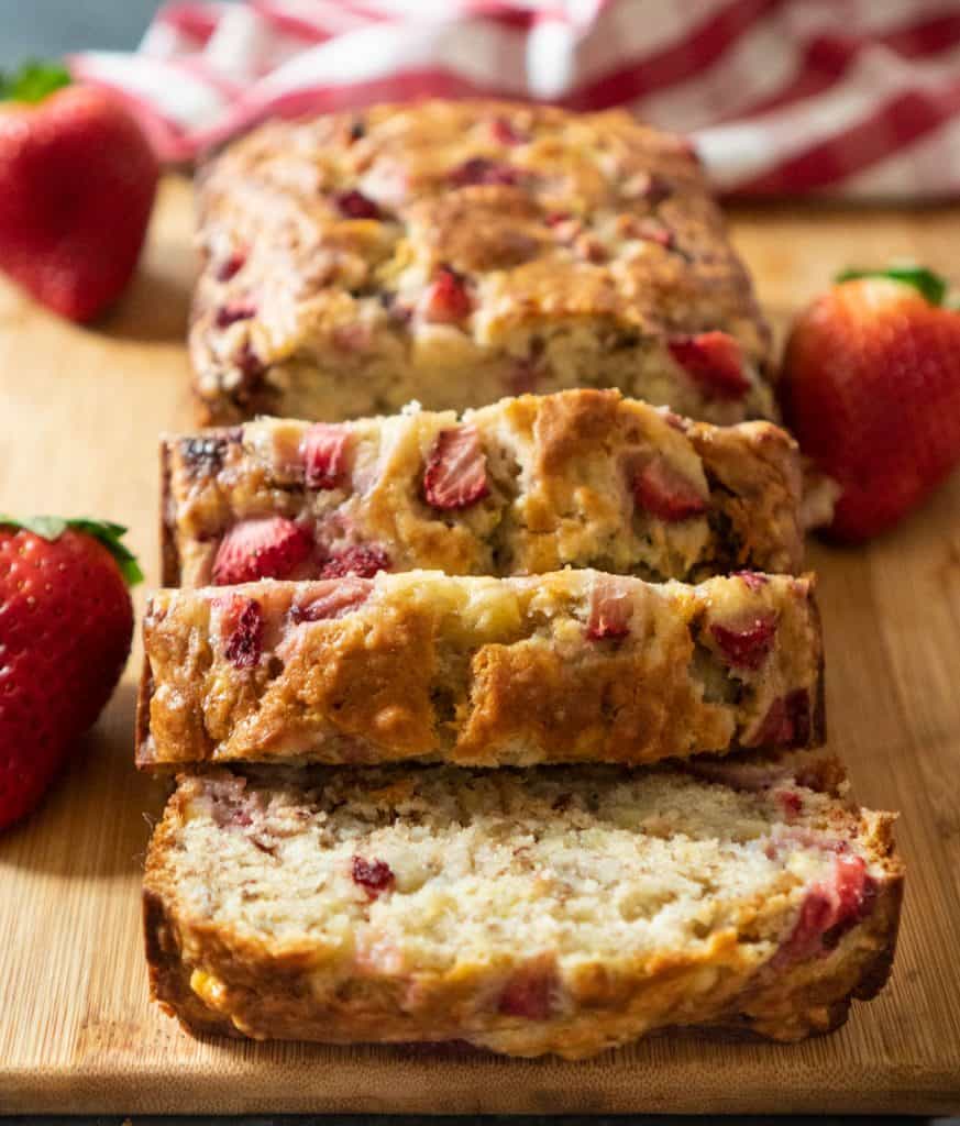 strawberry banana bread sliced on a cutting board