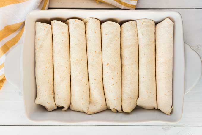 chicken enchiladas in casserole before adding cheese