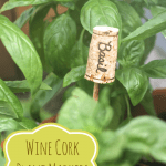A DIY wine cork plant marker titled "Basil" 