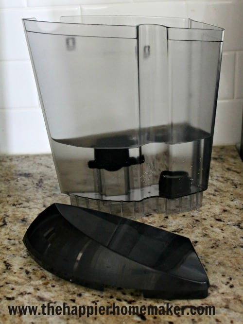 A close up of a Keurig coffee maker water carafe and how to clean it