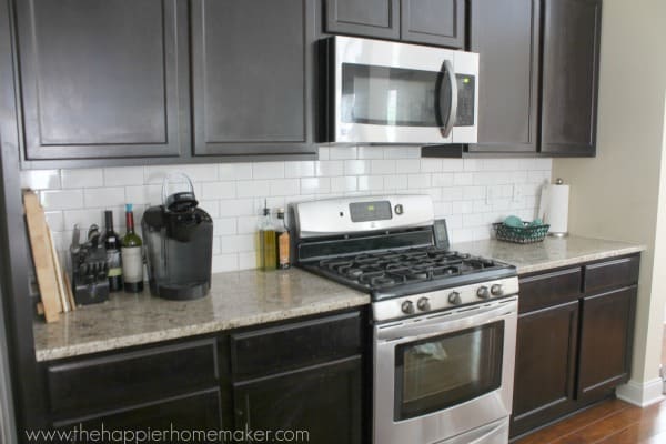 A white subway tile kitchen backsplash having the grout colored gray