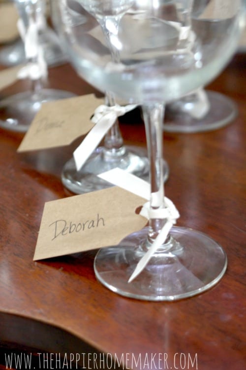 Wine tasting party cards tied to glass stems