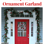 DIY ornament garland around a red door with white trim