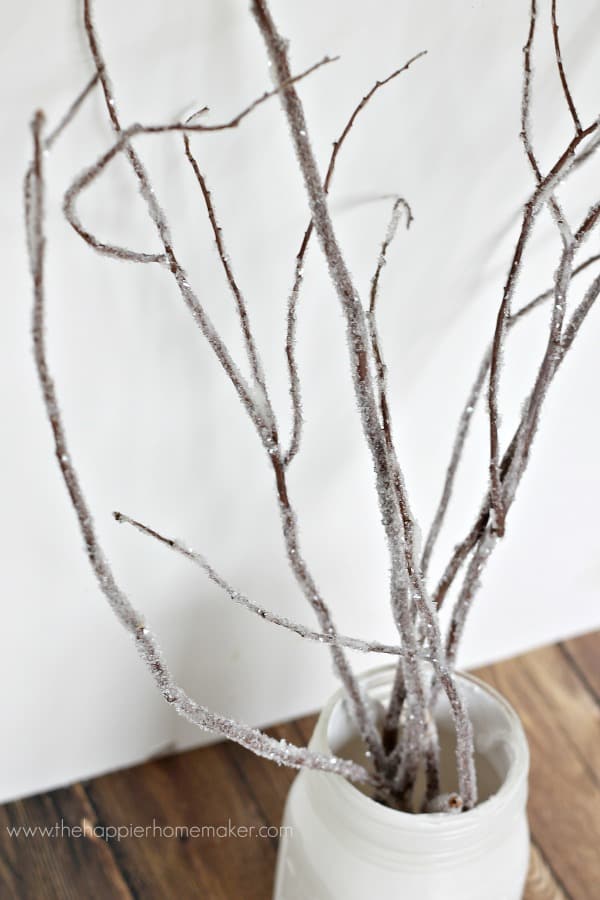A close up of DIY iced branches for winter decor