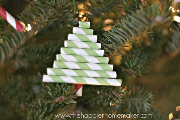 A close up of a DIY straw ornament shaped like a Christmas tree