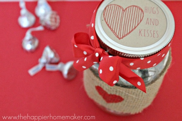 A close up of the top of a mason jar with Valentine's Day treats inside