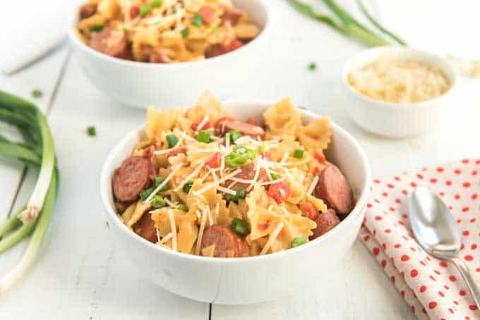 spicy tomato pepper sausage pasta in white bowls