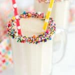 cake batter smoothie in glass with sprinkle and straw