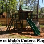 A picture of a play set and how to mulch around it
