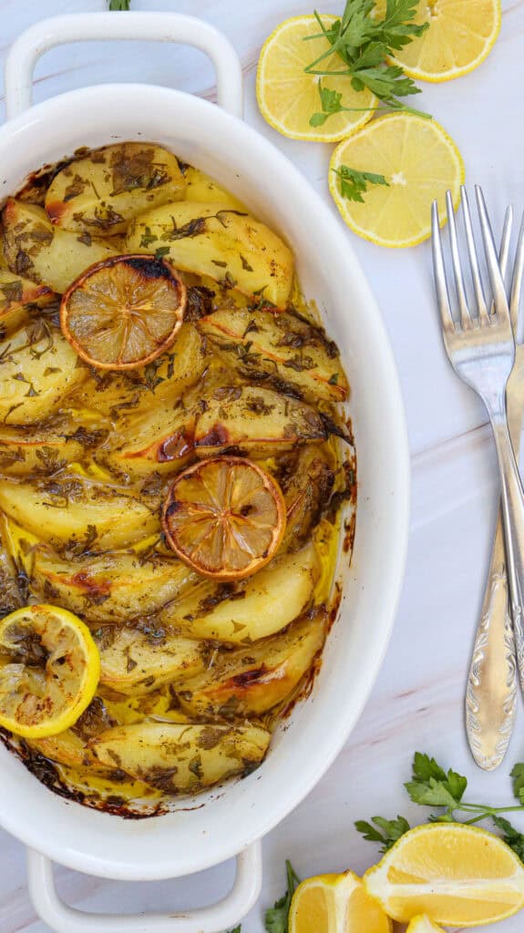 Greek lemon potatoes in white baking dish