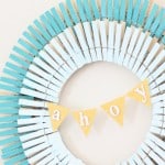 A DIY summer clothespin wreath painted different shades of blue