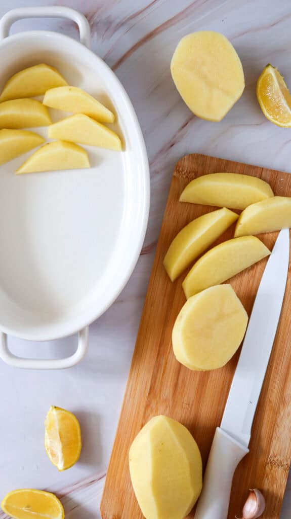 cutting peeled potatoes into wedges