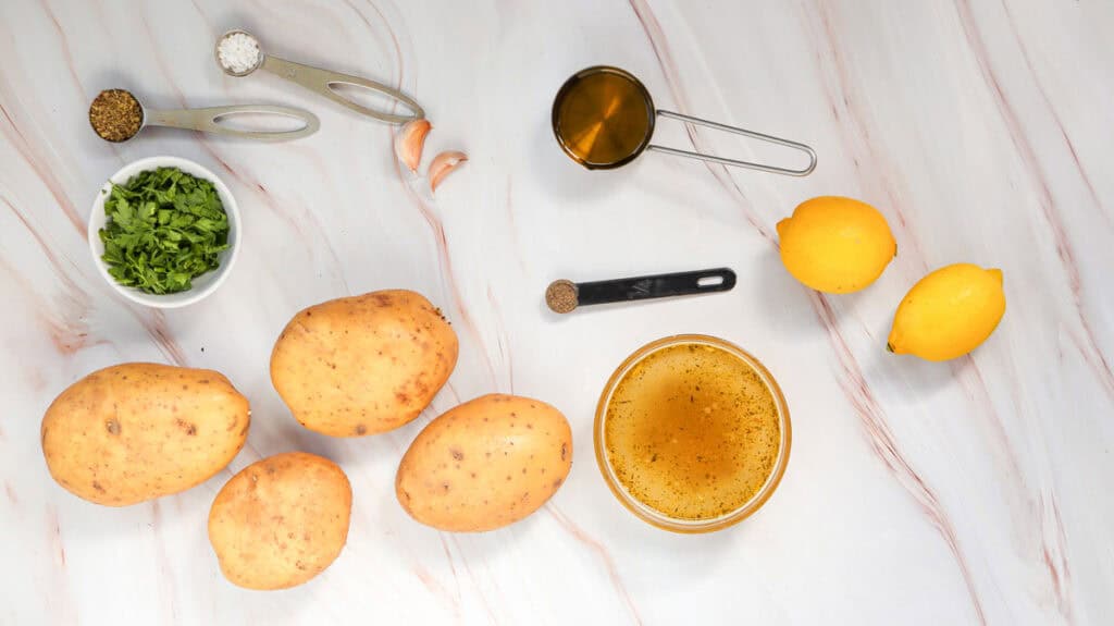 Greek lemon potatoes ingredients on countertop