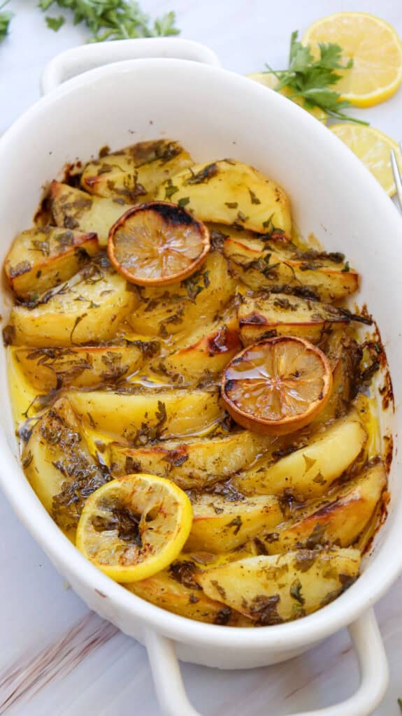 Greek lemon potatoes in white baking dish