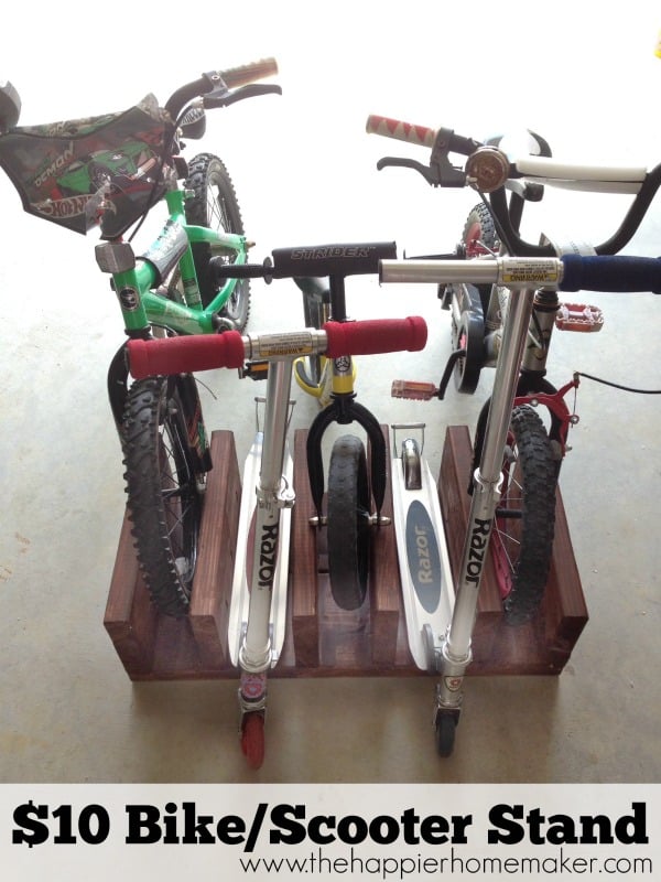 A DIY $10 wood bike rack holding small bikes and scooters
