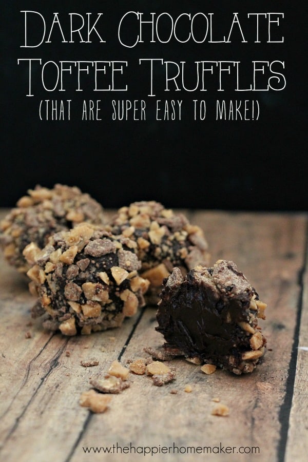 A close up of chocolate toffee truffles with one showing the chocolate inside