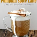 pumpkin spice latte with whipped cream and cinnamon stick in glass mug