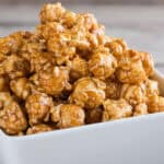 close up of caramel corn in white bowl