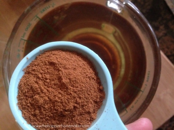 spoonful of cinnamon over jar of wax