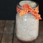 cinnamon candle in jar with orange bow