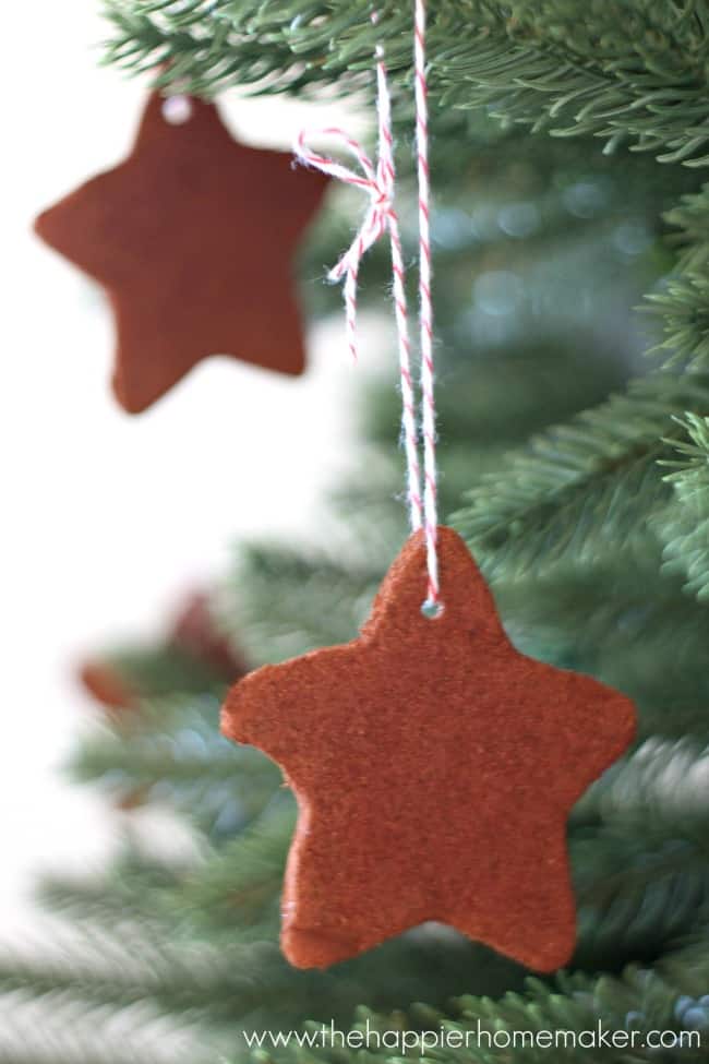 Cinnamon dough ornaments handing on Christmas tree with twine