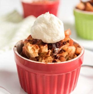 crustless apple pie in red ramekin topped with whipped cream