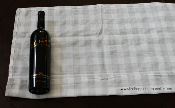 bottle of wine laying on a tea towel