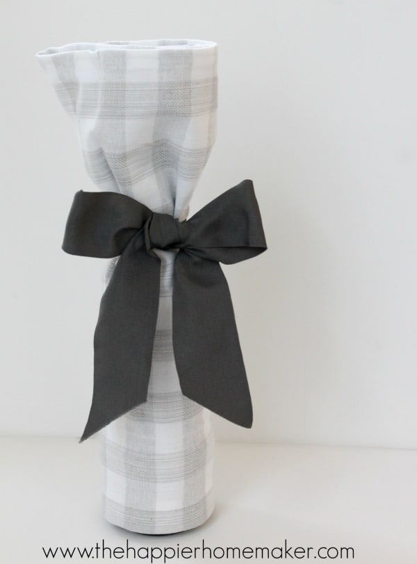 wine bottle wrapped in a tea towel with bow