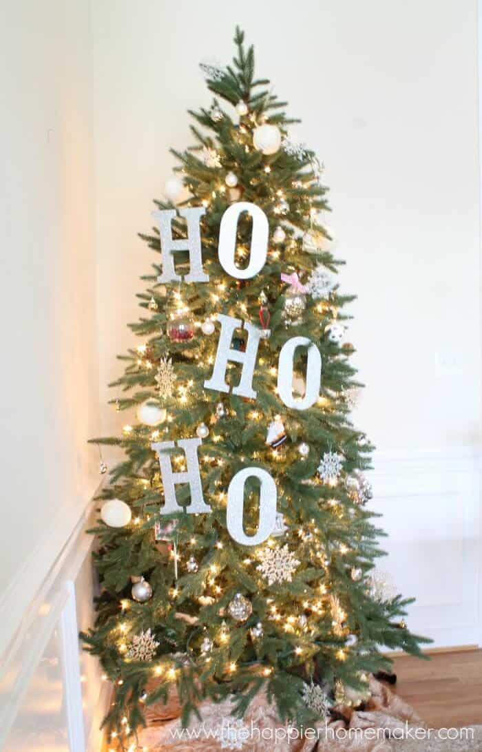 A close up of homemade Ho, Ho, Ho signs on a Christmas tree