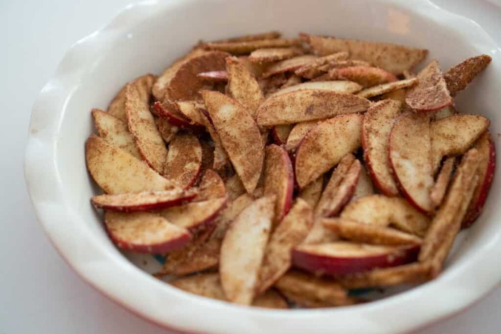 brown sugar coated apple slices in pie pan