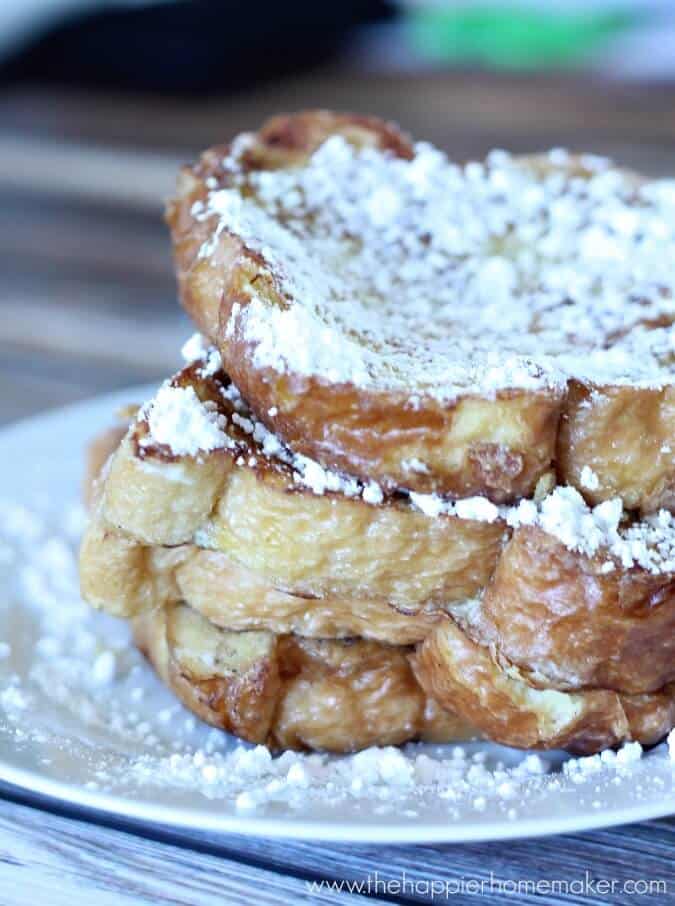A close up of french toast topped with powdered sugar