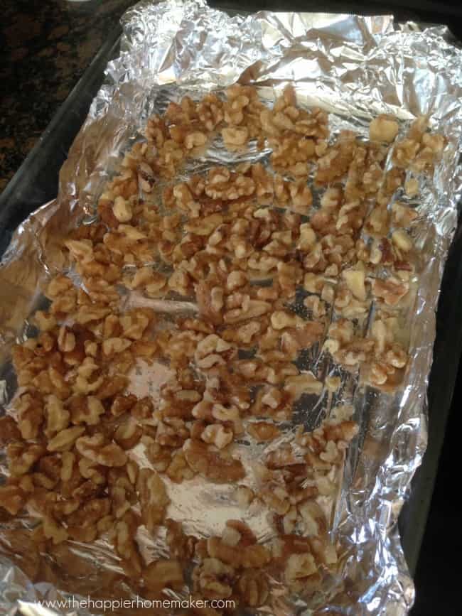 baking sheet lined with foil with walnuts on it