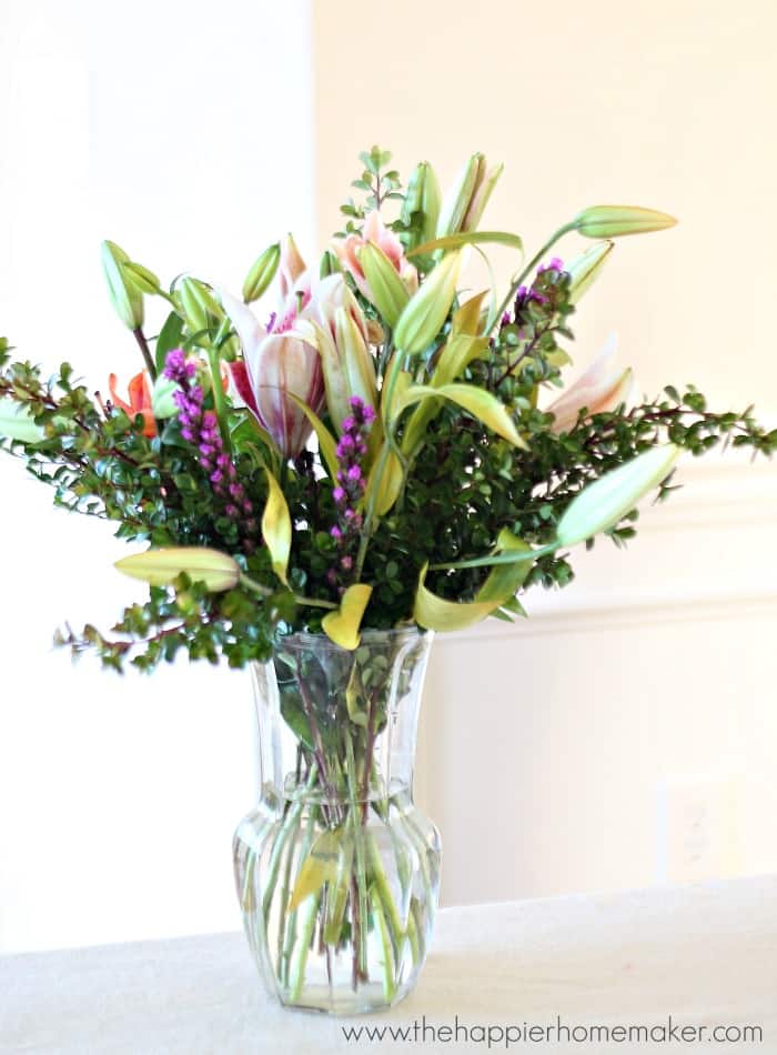 arranged grocery store bouquet in clear vase with lilies