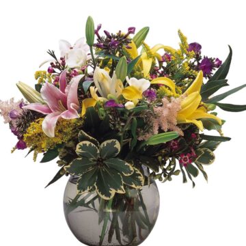 A vase full of different purple, yellow, green and pink flowers