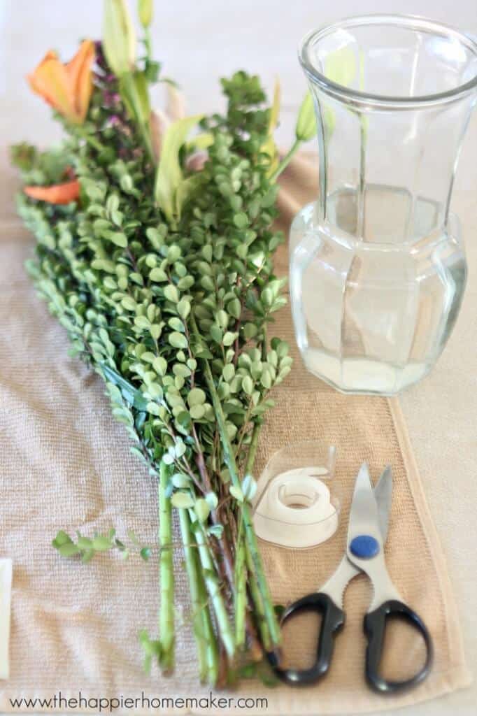 An in-process picture of how to arrange grocery store flowers to make them appear more full