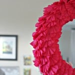 A close up of half of a dark pink Valentine's Day crepe paper ruffle wreath