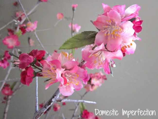 faux flowers on branch domestic imperfection