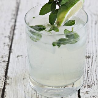 A skinny Mojito topped with a lime and mint