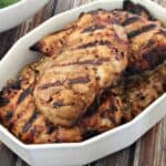 grilled chicken breasts in white dish
