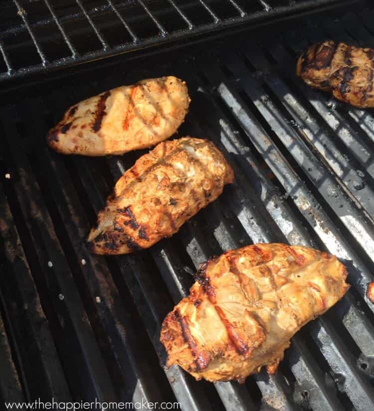 chicken breasts cooking on grill
